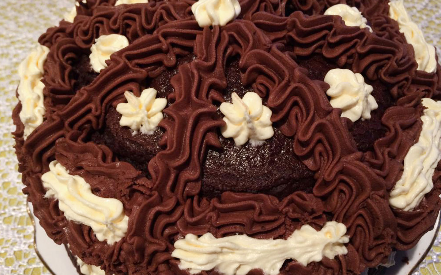 Close up of rich chocolate cake with cream swirls